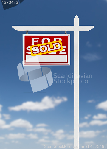 Image of Left Facing Sold For Sale Real Estate Sign on a Blue Sky with Cl