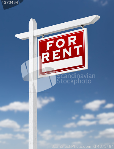 Image of Right Facing For Rent Real Estate Sign on a Blue Sky with Clouds