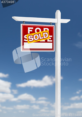 Image of Left Facing Sold For Sale Real Estate Sign on a Blue Sky with Cl