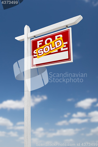 Image of Right Facing Sold For Sale Real Estate Sign on a Blue Sky with C