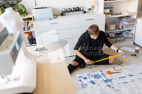 Image of fashion designer making dress at sewing studio