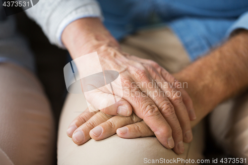 Image of close up of senior couple holding hands