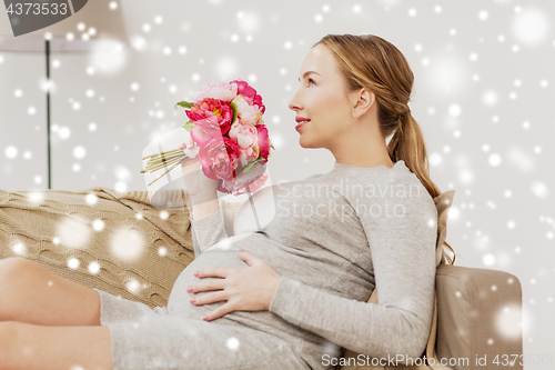 Image of happy pregnant woman with flowers at home