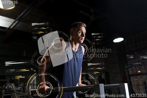 Image of man doing triceps dip on parallel bars in gym