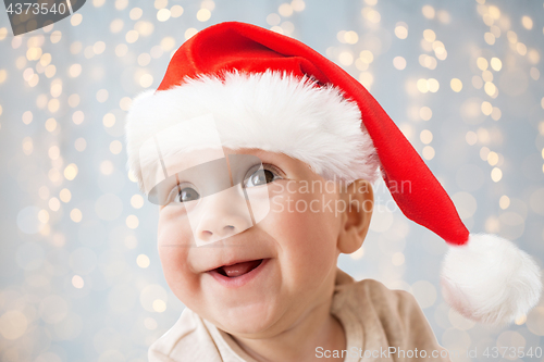 Image of close up of happy little baby boy in santa hat