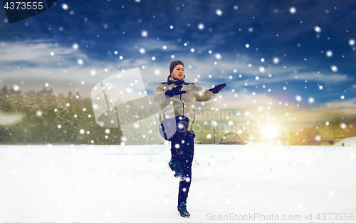 Image of man exercising and warmig up in winter outdoors