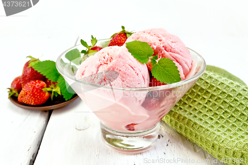 Image of Ice cream strawberry in glass with berries on board