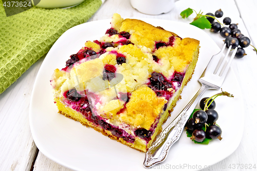 Image of Pie with black currant in plate with fork on light board