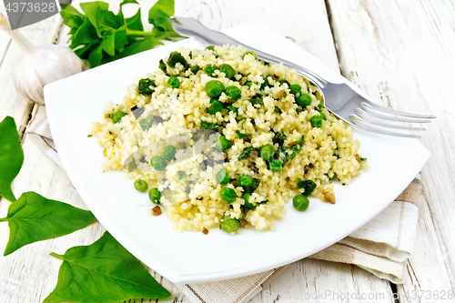 Image of Couscous with spinach in plate on light board