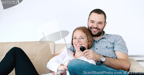 Image of senoior couple watching tv in modern villa