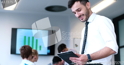 Image of Businessman using tablet in modern office