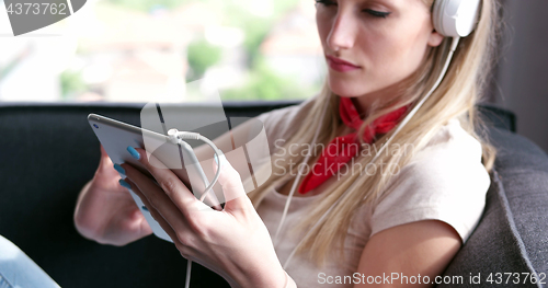 Image of woman using tablet in beautiful apartment