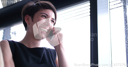 Image of Business Girl Standing In A Modern Building Near The Window With