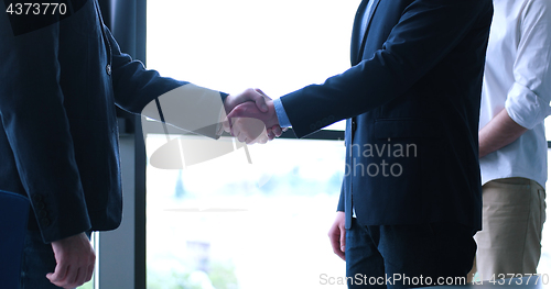 Image of cloasing the deal in modern office interior