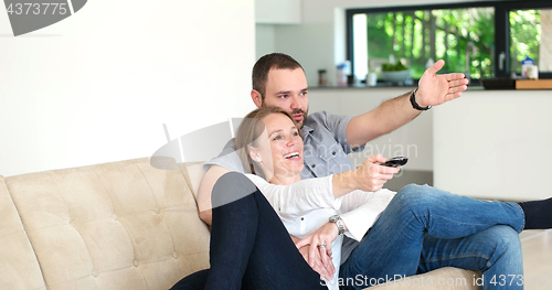 Image of senoior couple watching tv in modern villa