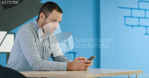 Image of Senior businessman  using cell phone at  stratup office