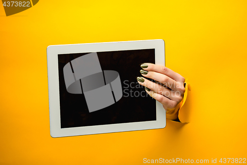 Image of female teen hands using tablet pc with black screen, isolated