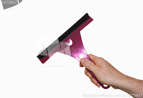 Image of hand holding a tool for cleaning the glass