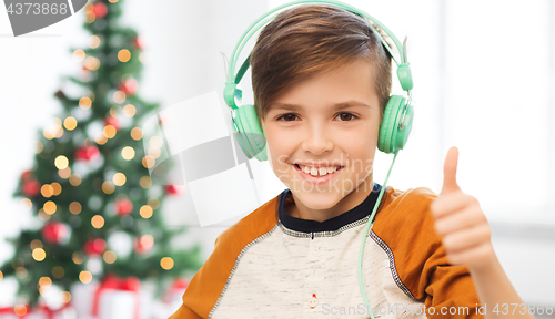 Image of boy in headphones showing thumbs up at christmas