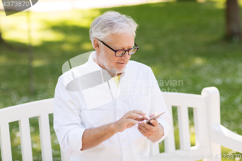 Image of senior man with smartphone at summer park