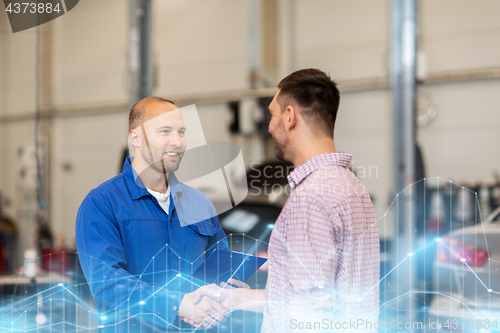 Image of auto mechanic and man shaking hands at car shop