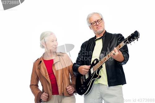Image of happy senior couple with electric guitar