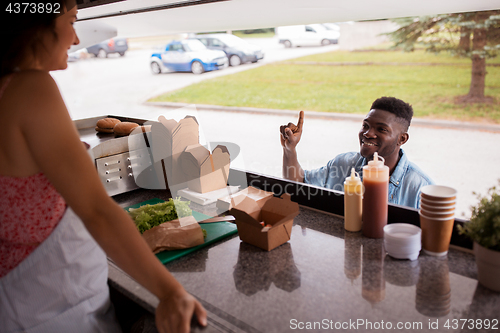 Image of african american man ordering wok at food truck