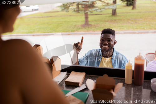 Image of african american man ordering wok at food truck