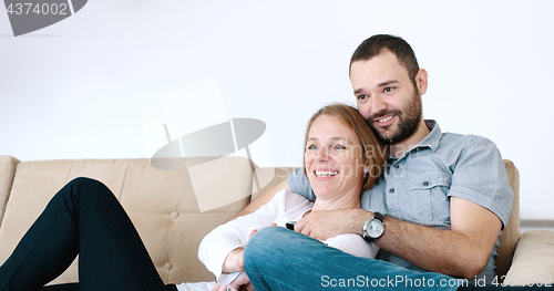 Image of senoior couple watching tv in modern villa