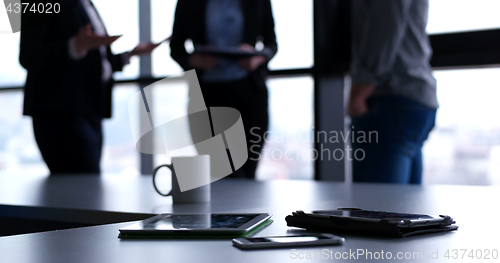 Image of tablet, mobile cell phone and cup of coffee  in office with busi