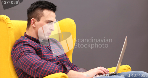 Image of businessman working using a laptop in startup office