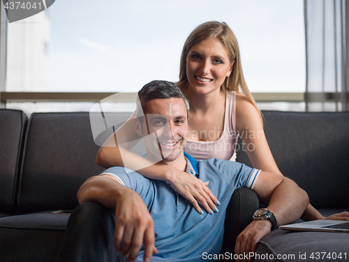 Image of Attractive Couple Using A Laptop on couch