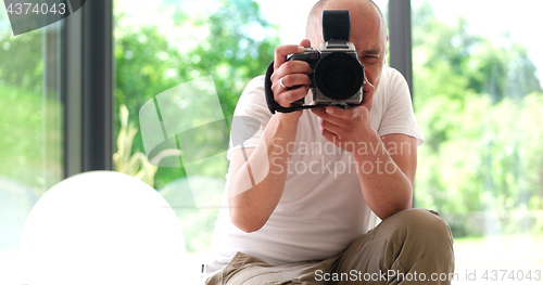 Image of Photographer takes pictures with DSLR camera