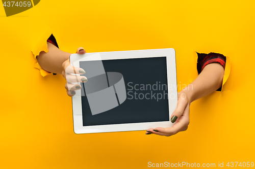 Image of female teen hands using tablet pc with black screen, isolated