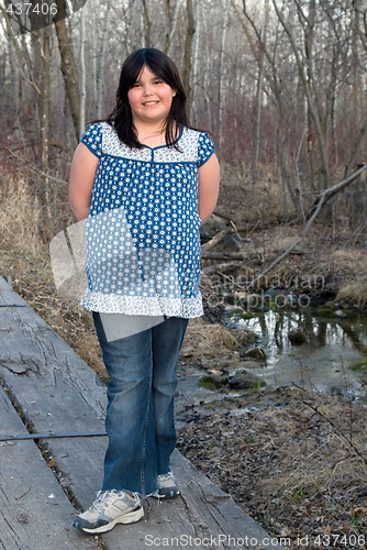 Image of Girl Standing on Wooden Bridge