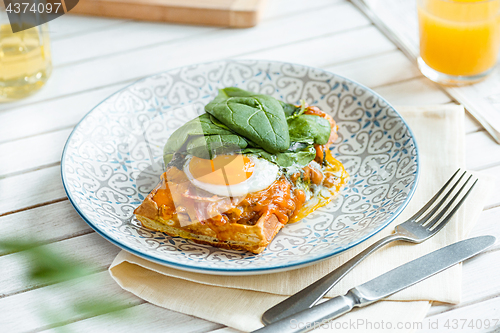 Image of Scrambled eggs on meat with fried potatoes and toast