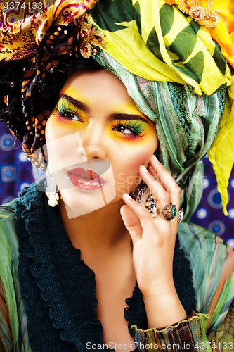 Image of beauty bright woman with creative make up, many shawls on head like cubian