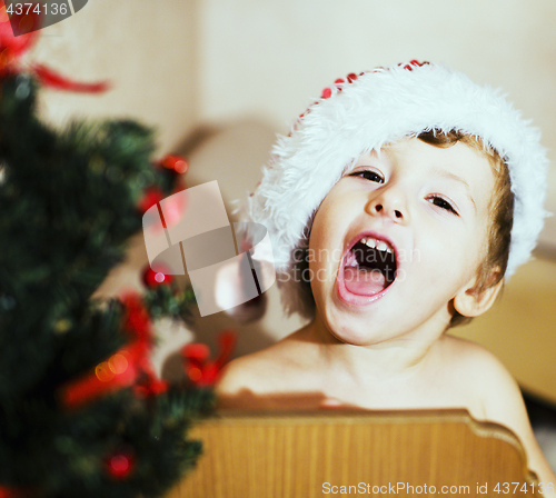 Image of portrait of little cute boy in Christmas in red hat
