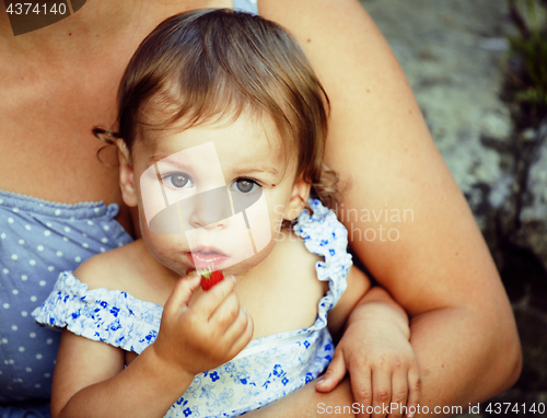 Image of little girl with mother outside