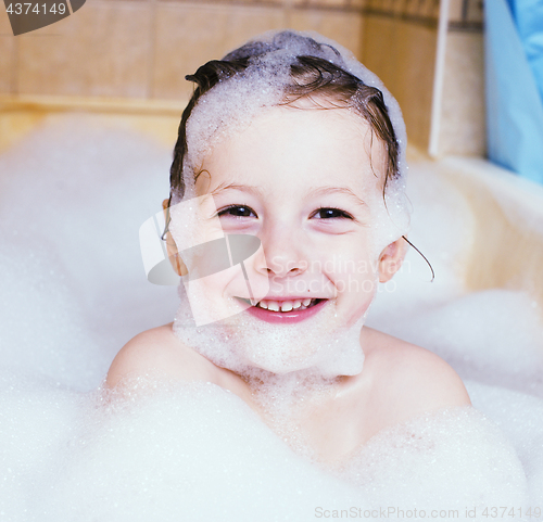 Image of little cute boy in bathroom with bubbles close up