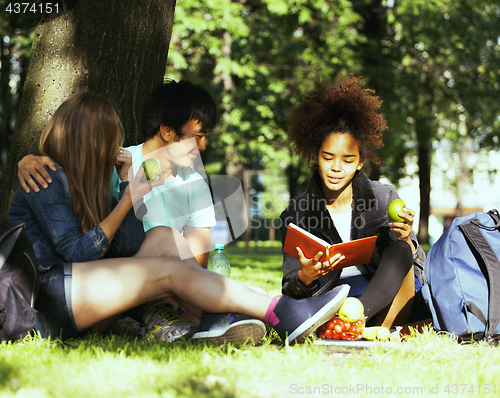 Image of cute group of teenages at the building of university with books huggings, diversity nations