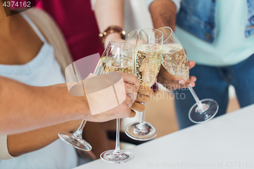 Image of friends clinking glasses of champagne at party