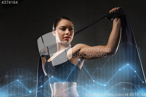 Image of woman with expander exercising in gym