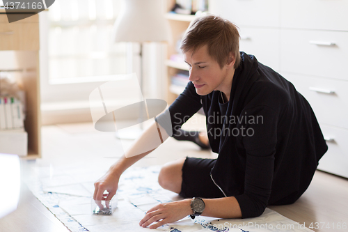 Image of fashion designer with cloth making dress at studio