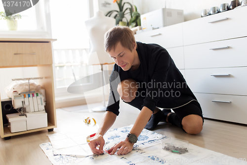 Image of fashion designer making dress at sewing studio