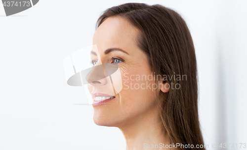 Image of face of happy smiling middle aged woman