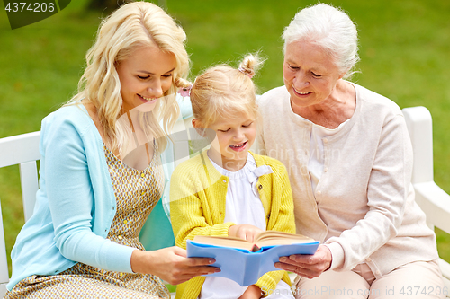 Image of woman with daughter and senior mother at park