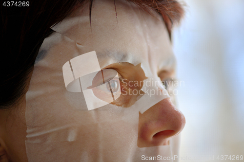 Image of Woman with facial mask sheet