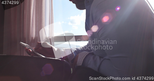 Image of Business Man Talking On Cell Phone At Home