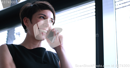 Image of Business Girl Standing In A Modern Building Near The Window With